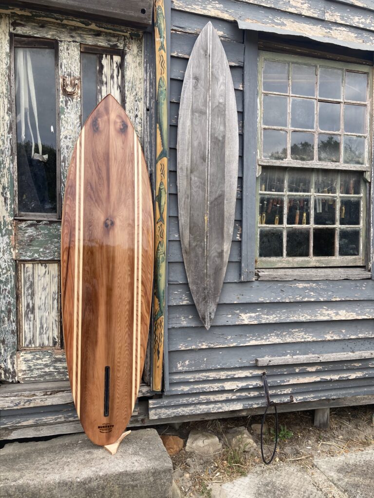 Custom wooden surfboards: Hollow wooden surfboard with western red cedar bottom and pinstripes in wood.